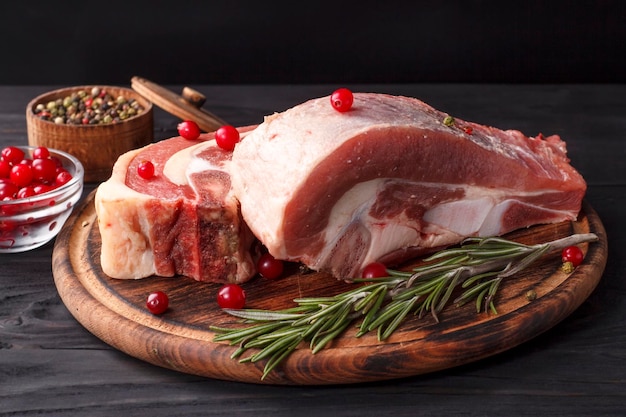 Several pieces of fresh raw beef brisket on the bone with rosemary