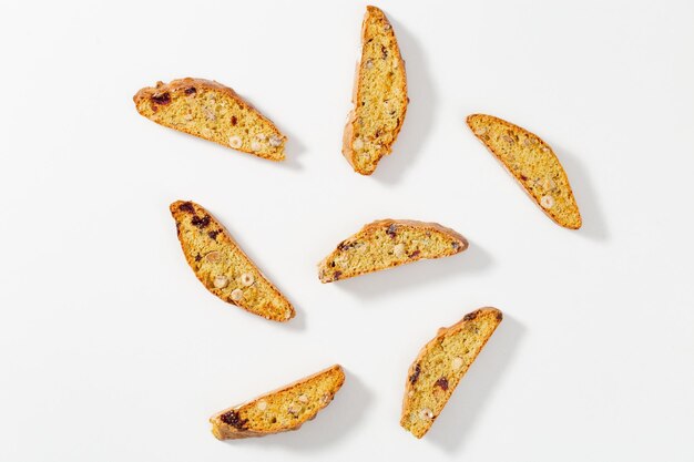 Several pieces Italian biscotti cookies on black baking sheet Fresh baked cookies with nuts