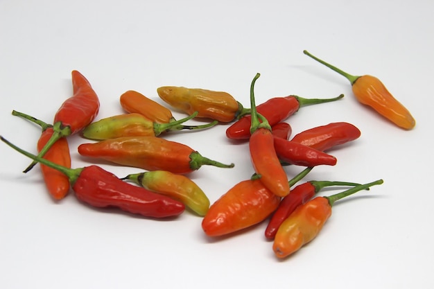 several red peppers are laying on a white surface