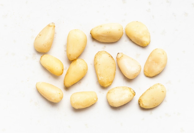 Several shelled pine nuts close up on gray