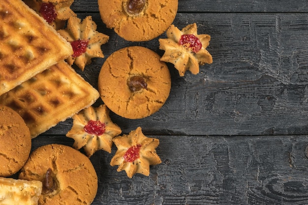 Several types of fresh cookies on a wooden table