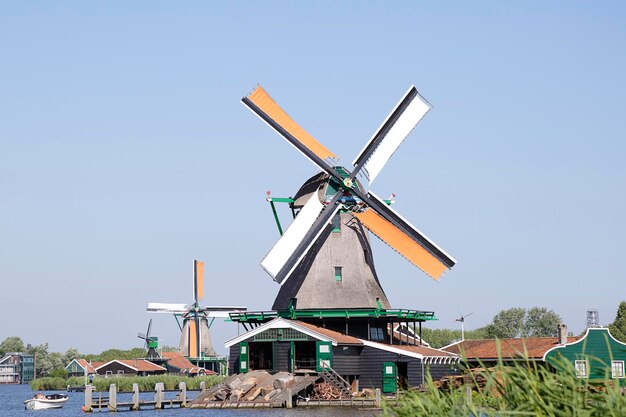 Several windmills of Zaanse Schans against blue sky The Netherlands