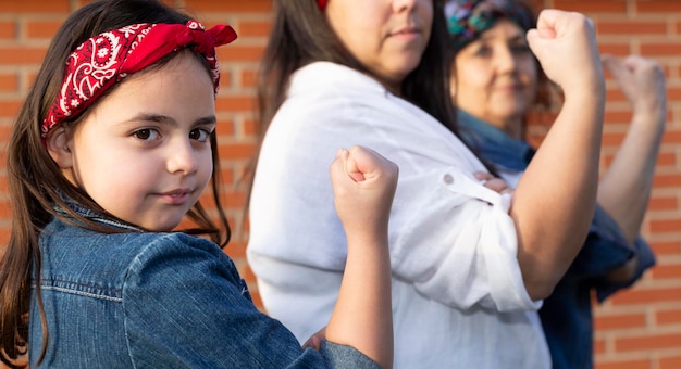 Photo several women of different generations with their fist raised in protest. concept of feminist future. women's day.