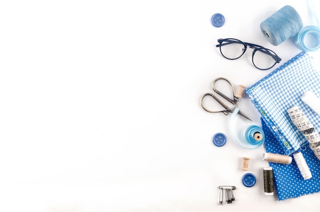 Sewing accessories and fabric on a white background