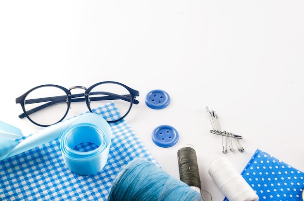 Sewing accessories and fabric on a white background