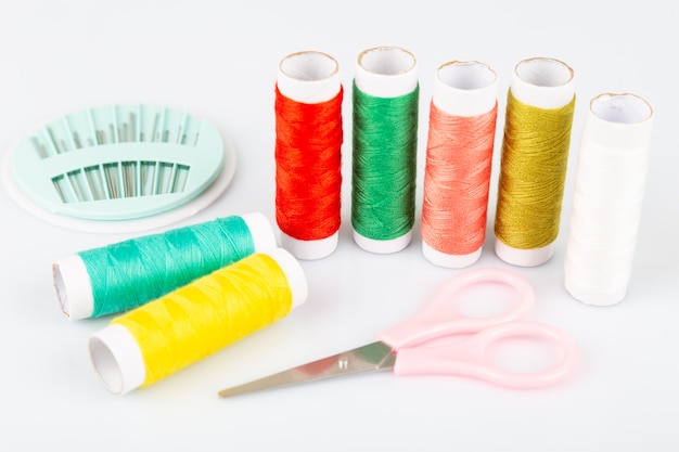 Sewing kit with colorful spools of threads and instruments