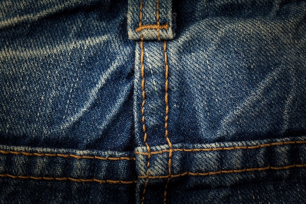 Sewing line of vintage blue jeans