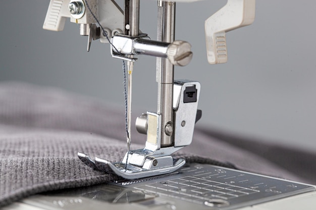 Sewing machine stitching fabrics needle in a round plan close up