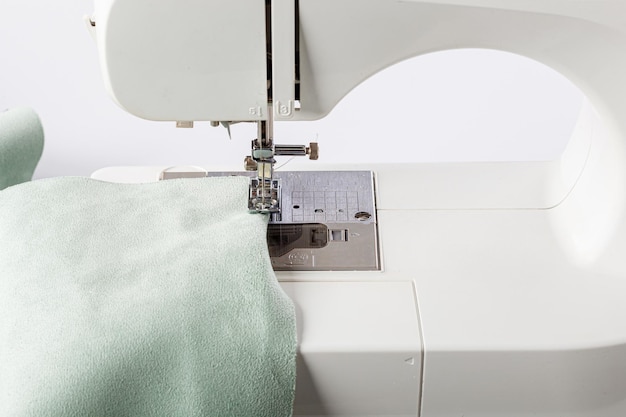 Sewing machine stitching fabrics needle in a round plan close up