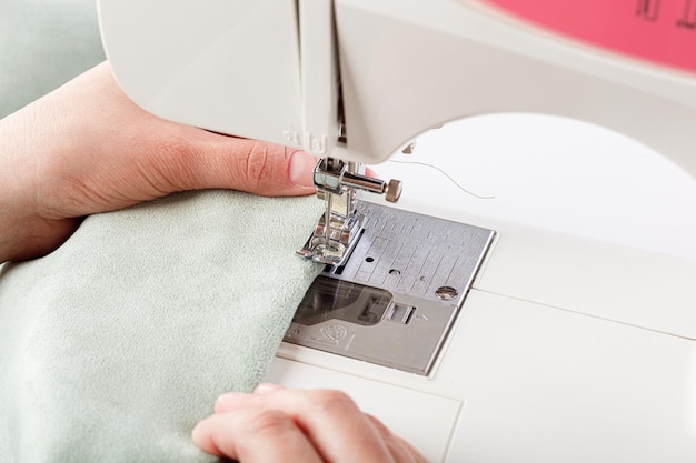 Sewing machine stitching fabrics needle in a round plan close up