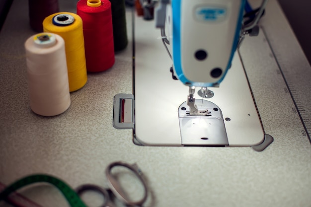 A sewing machine with equipment. Manufacture of wearing and fashion concept