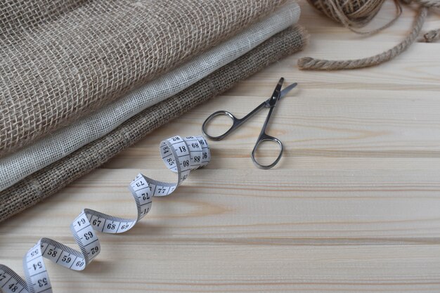 Sewing supplies on a wooden background