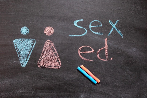 Photo sex education with gender symbols written on a blackboard. copyspace