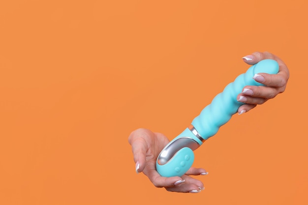 A sex toy Vibrator on an orange background Leisure Copy space