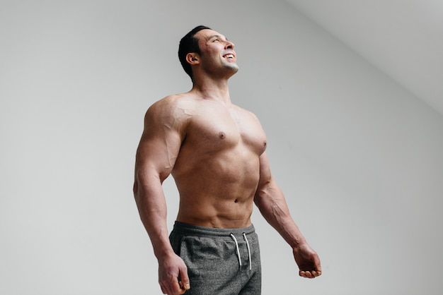 Sexy athlete posing on a white background Topless. Fitness