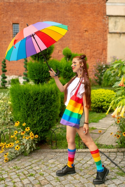 Sexy babe in colorful clothes and lgbt flag on her posing outdoors.