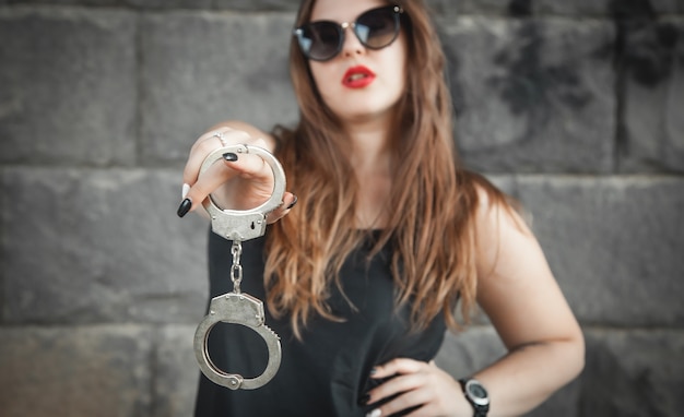 Sexy beautiful woman holding handcuffs.