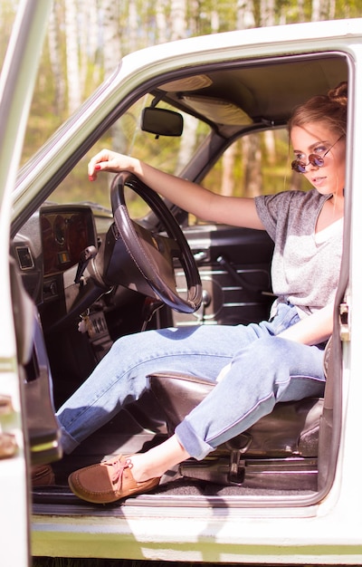 Sexy beautiful young woman is sitting in the car