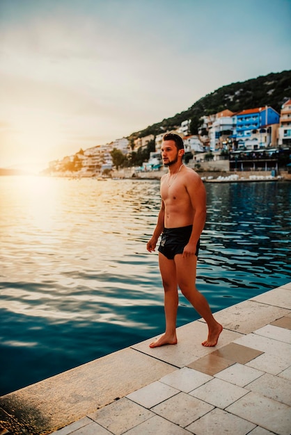 Sexy Fit man posing at the beach