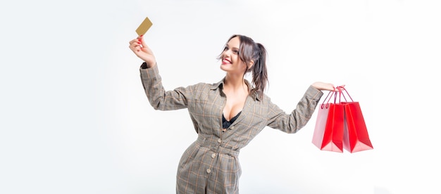 Sexy girl posing with a discount card and red bags