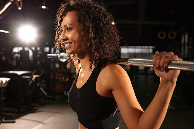 Sexy gorgeous african american woman working out with a barbell in the gym copyspace sports lifestyle wrestling be in good shape