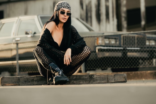 Photo sexy hipster woman wearing sunglasses and bandana black boots and jacket cheeky fashion girl hiphop