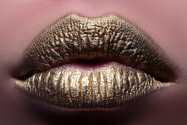 Sexy lips closeup sexy beautiful female golden lips isolated gold lipstick