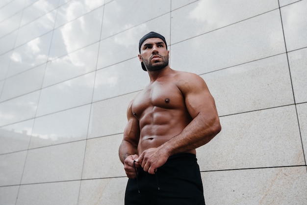 Sexy man posing topless in the hot sun. Fitness. Lifestyle