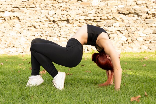 Sexy model doing yoga outdoors Athlete in a deflection Back exercise