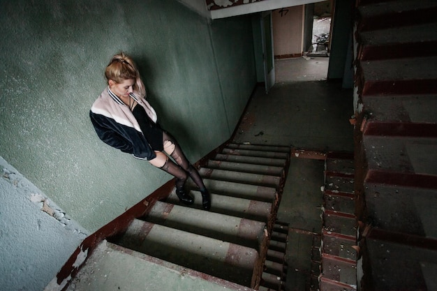 Sexy pinup girl in underwear posing in abandoned building