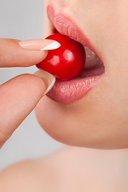 Sexy red lips with cherry isolated on white