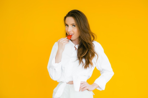 Sexy Woman Eating Strawberry Sensual Red Lips Red Manicure and Natural Lipstick