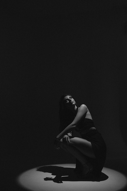 Sexy woman in studio. Woman in black dress on white