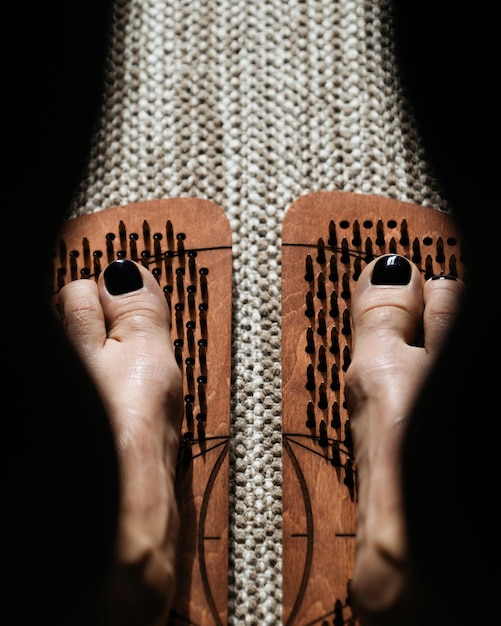 Shadow and light play over wooden acupressure boards with protruding pegs