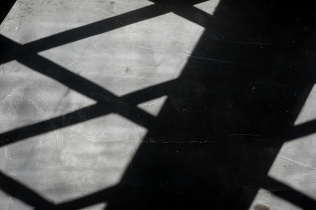 The shadow of the metal grill on the dark window sill The texture of the plaster