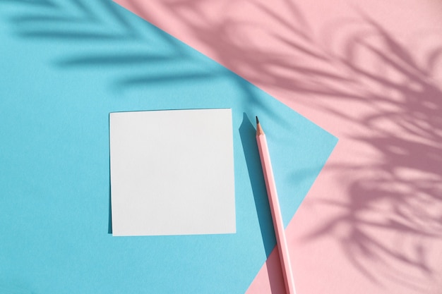 Shadow of tropical palm tree leaves and empty paper