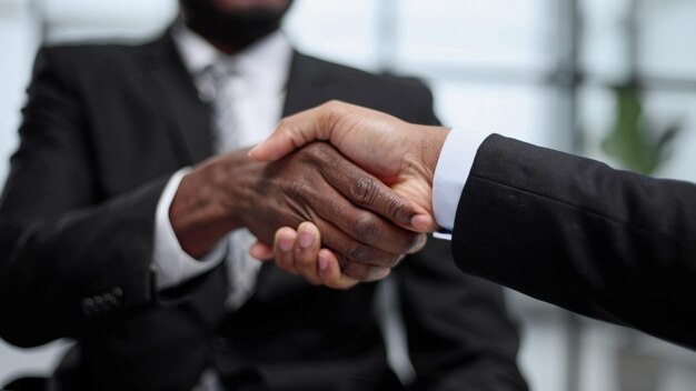 Shaking hands with real estate agent in the office