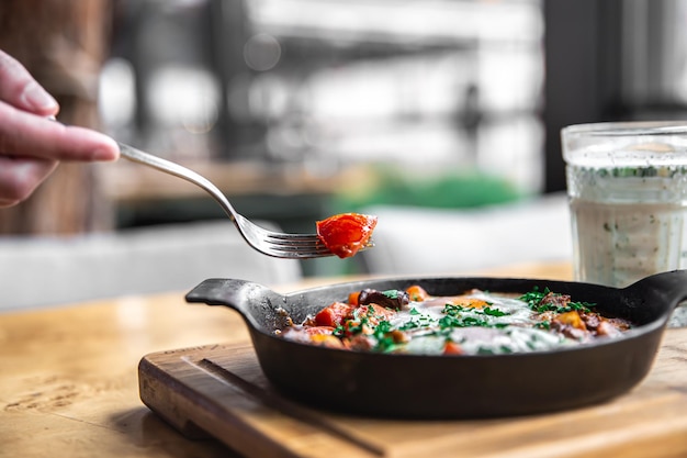 Shakshuka in a frying pan and a glass of ayran healthy and tasty food