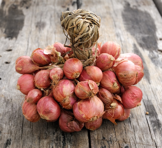 Shallot onions in a group on wood