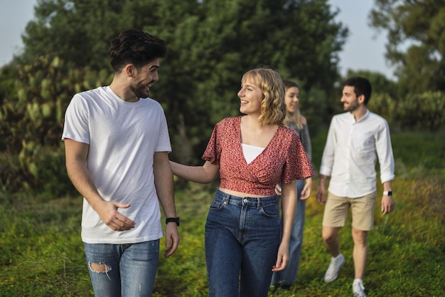 Shallow focus shot of Spanish Caucasian young friends hanging out in a park, two couple