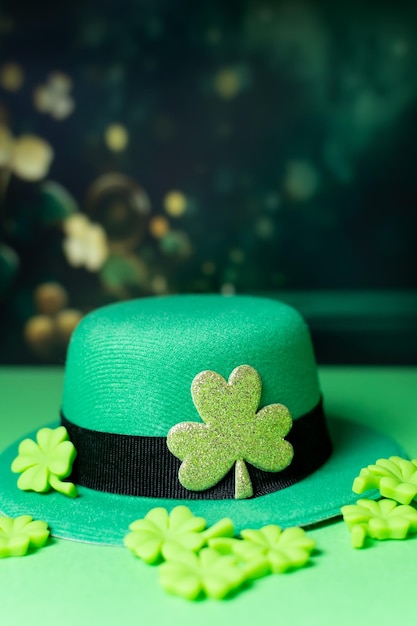 Shamrocks and leprechaun hats on green background with Copy space