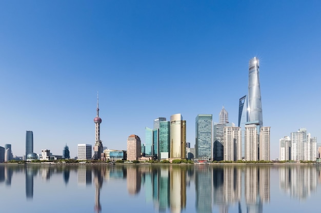 Shanghai skyline and reflection against a sunny sky abstract metropolis cityscape