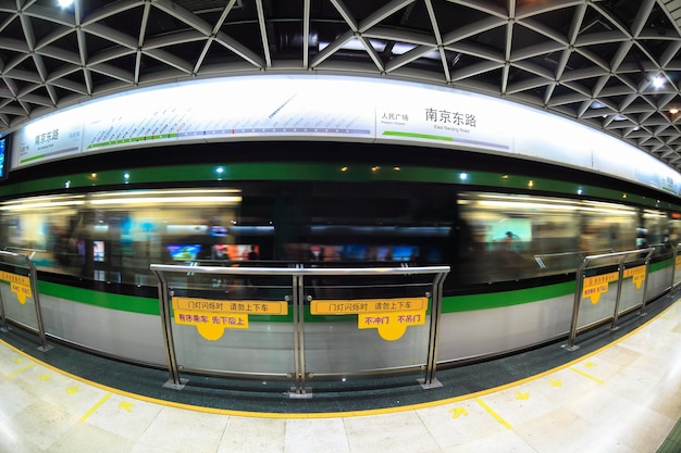 Shanghai subway station by fisheye view with train motion blur