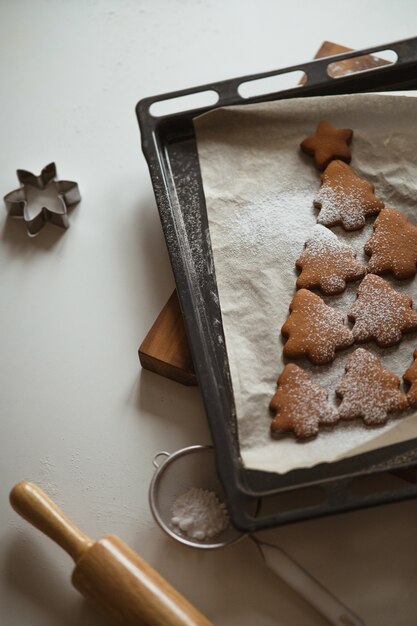 Shape of the christmas tree is made of gingerbread and powdered sugar