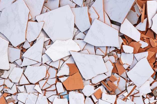 Shards of broken white ceramic tiles background