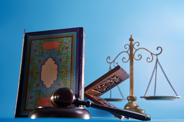 Sharia law concept gavel hammer libra scale and holly koran