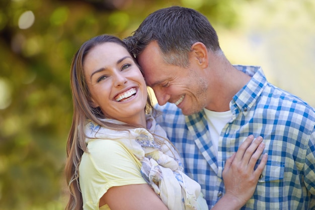 Sharing loving moments outdoors Portrait of an affectionate couple outside in the summer sun