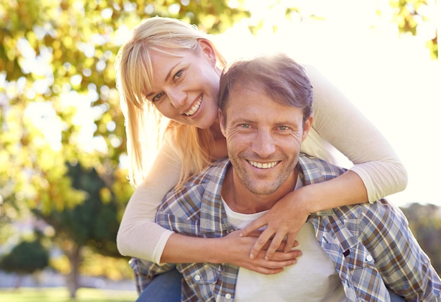 Sharing romantic moments Shot of a happy man piggybacking his wife