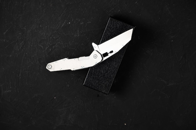 Photo sharp pocketknife on a black background