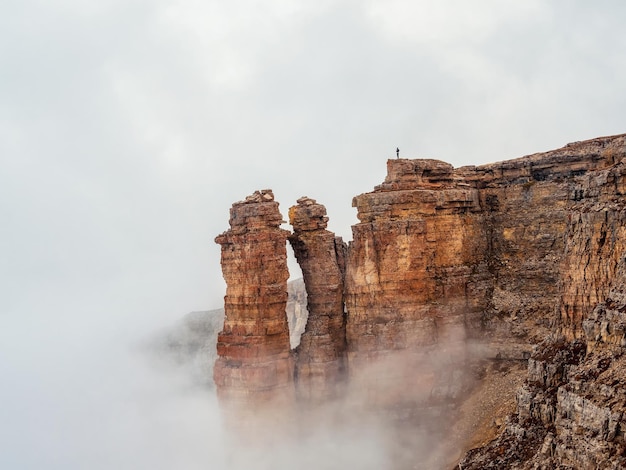 Sharp rocks in the fog Mountains in a dense fog Mystical landscape with beautiful sharp rocks in low clouds